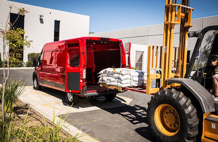 red 2017 Ram ProMaster Cargo Van being loaded with stuff