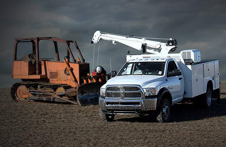 2018 Ram 5500 Chassis Cab next to a plow
