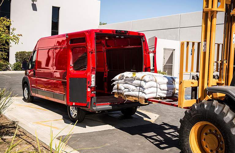 red 2018 ProMaster Cargo Van being loaded by a forklift