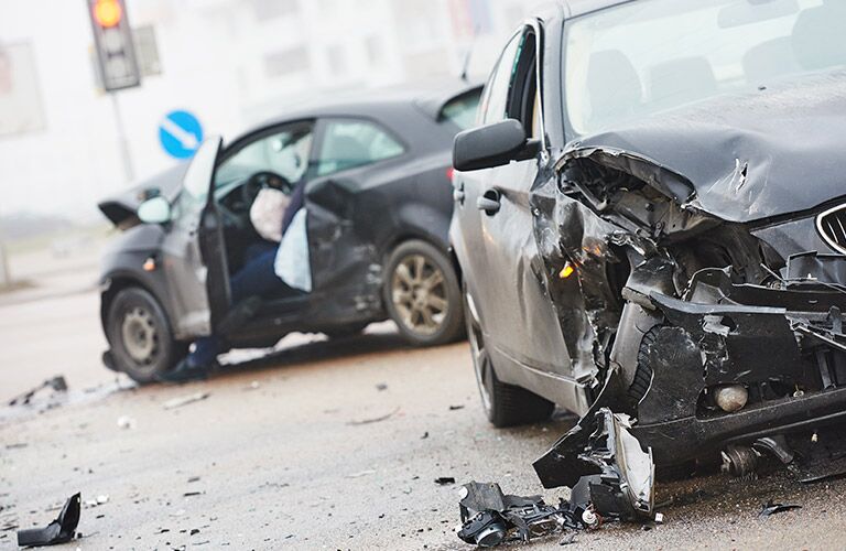 two cars pretty much destroyed after an accident