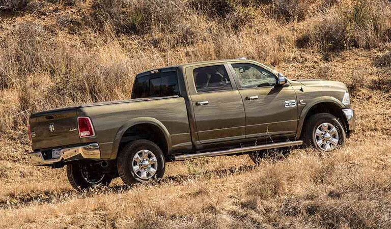 2016 Ram 2500 driving up a hill in a field