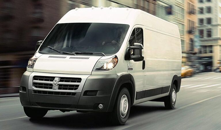 White Ram ProMaster Cargo Van driving against a blurred background