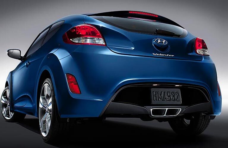 Rear view of blue 2017 Hyundai Veloster on silver background Rear view of blue 2017 Hyundai Veloster on silver background