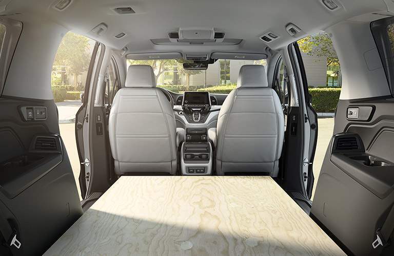 rear cargo area of the 2018 Honda Odyssey EX with a board where the seats are usually