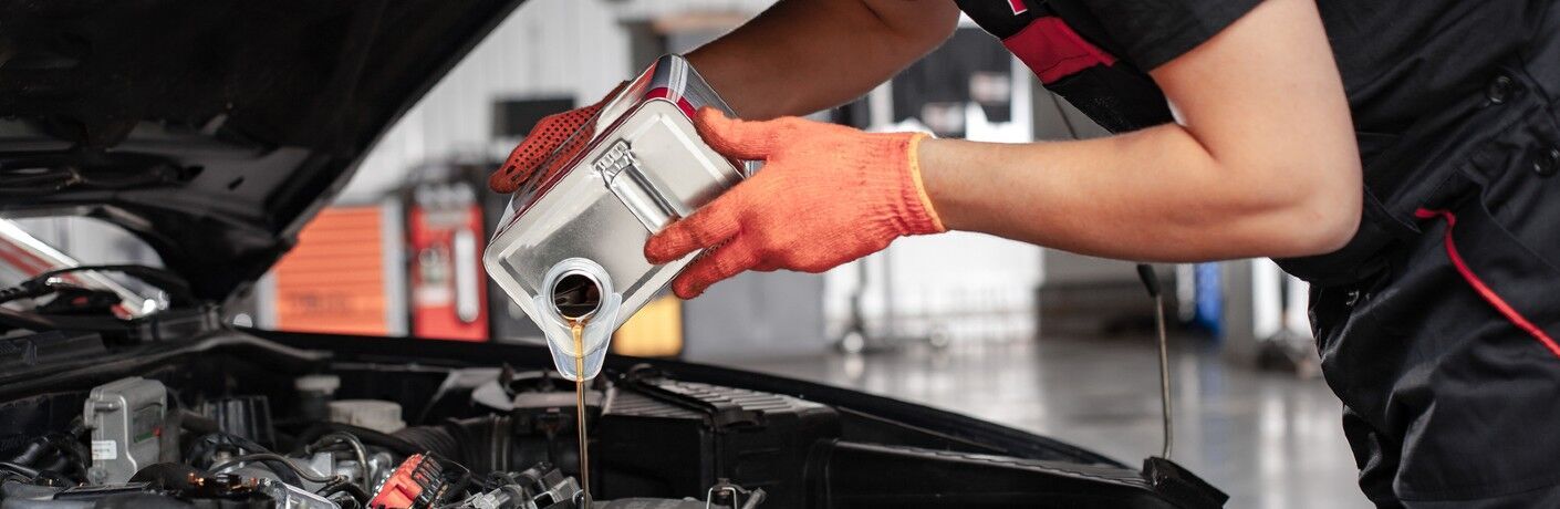 A mechanic is changing oil