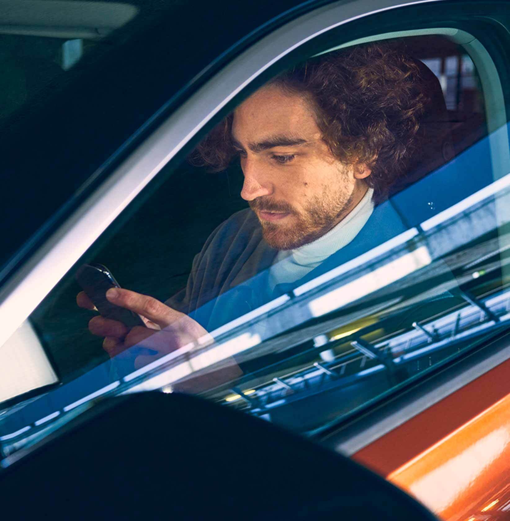 24 Hour Roadside Assistance Person in car on phone
