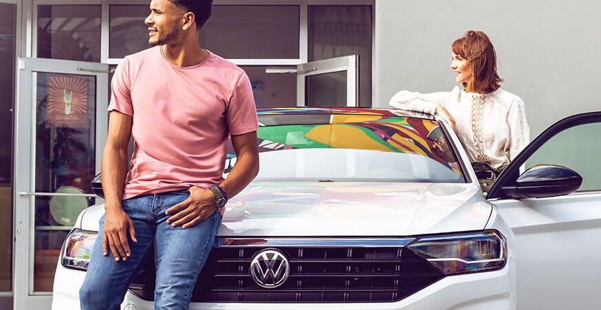 Model-Specific Limited Warranty Coverage Two people standing near a Volkswagen