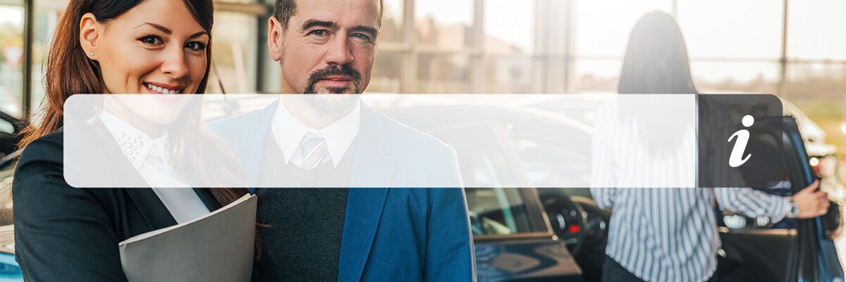 Portrait of two happy car sales consultants working inside vehicle showroom. Portrait of two happy car sales consultants working inside vehicle showroom.