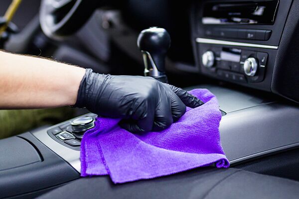 A man cleaning car interior, car detailing. A man cleaning car interior, car detailing.