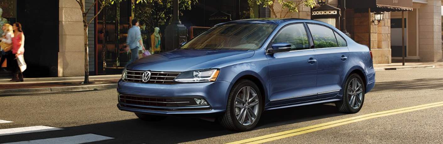 2018 Volkswagen Jetta Blue Compact Sedan Driving Through City Street