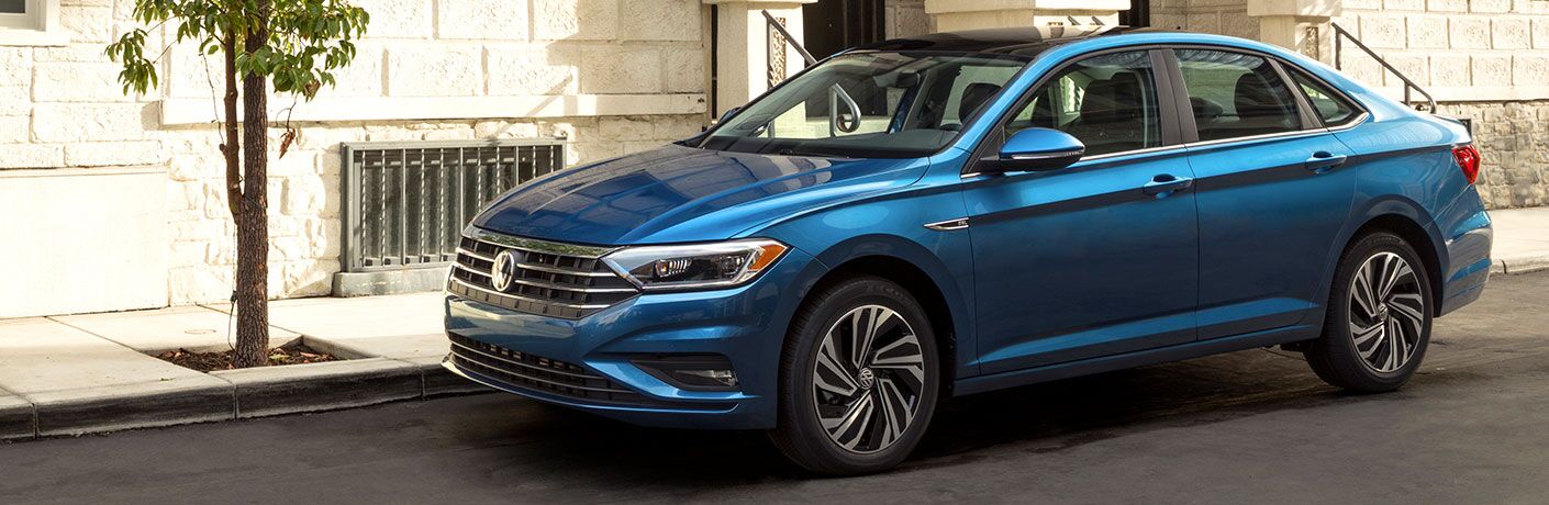 2019 Volkswagen Jetta parked next to city sidewalk