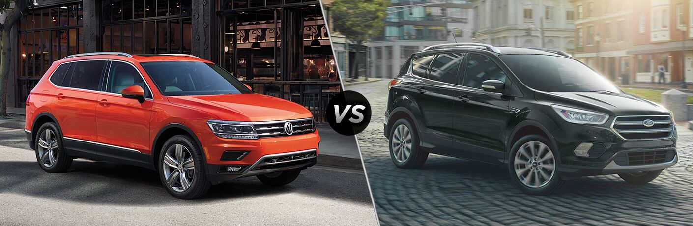Front passenger view of an orange 2019 Volkswagen Tiguan on left VS front passenger angle of a black 2019 Ford Escape on right