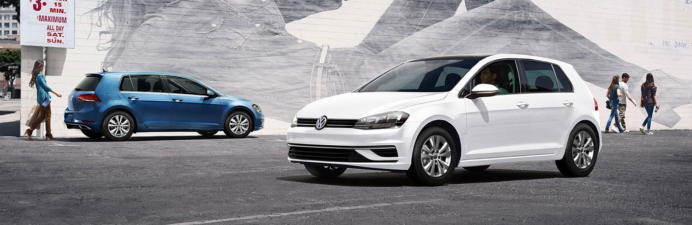 Two 2020 Volkswagen Golf hatchbacks parked next to each other
