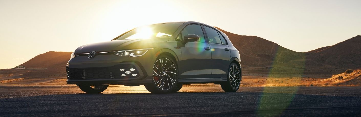 2022 VW Golf GTI Gray in a desert at sunset