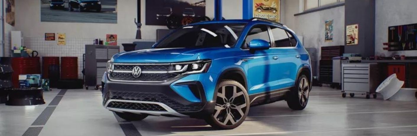 A blue 2022 Volkswagen Taos in a showroom.
