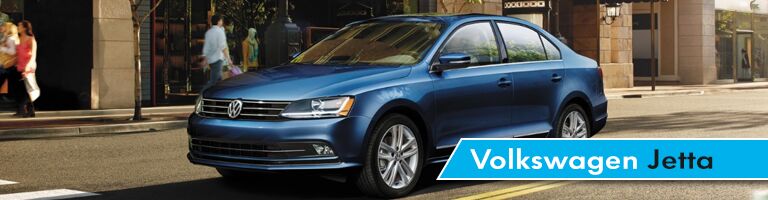Blue 2018 VW Jetta in an urban setting