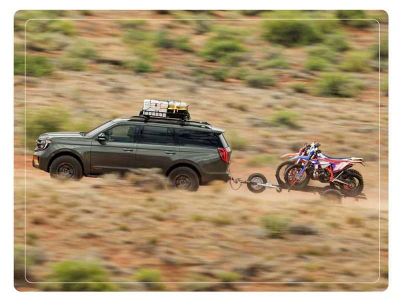 The 2025 Ford Expedition towing a trailer through the desert. The 2025 Ford Expedition towing a trailer through the desert.