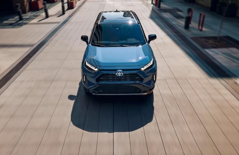 The front profile of a blue 2022 Toyota RAV4 Hybrid.