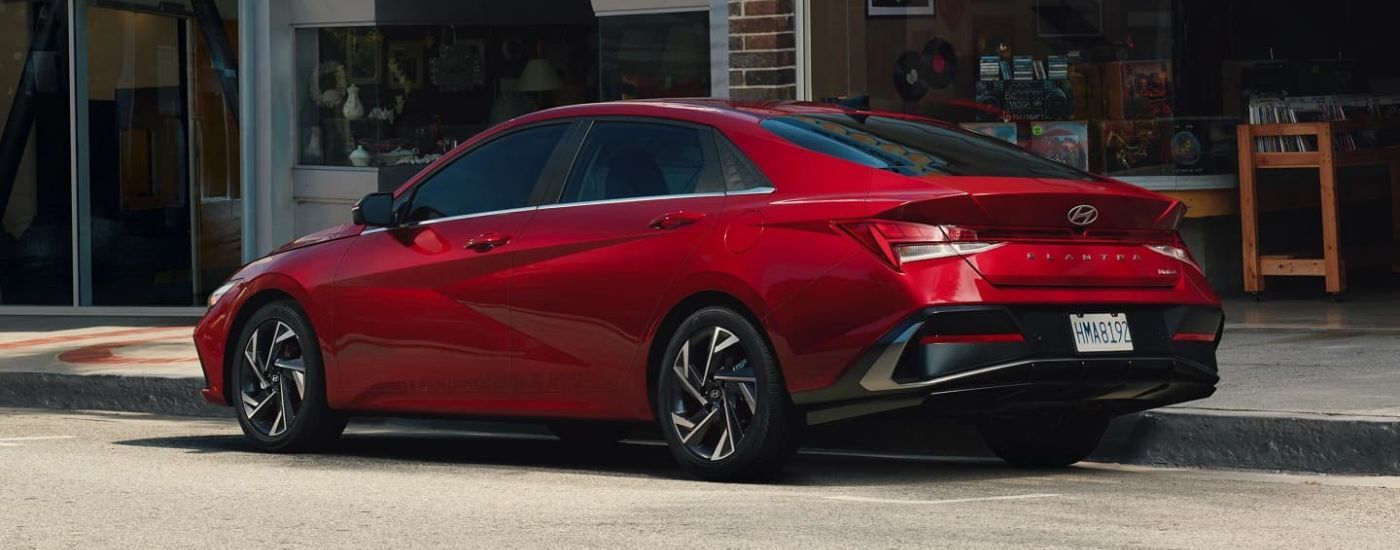 A red 2024 Hyundai Elantra parked in a city