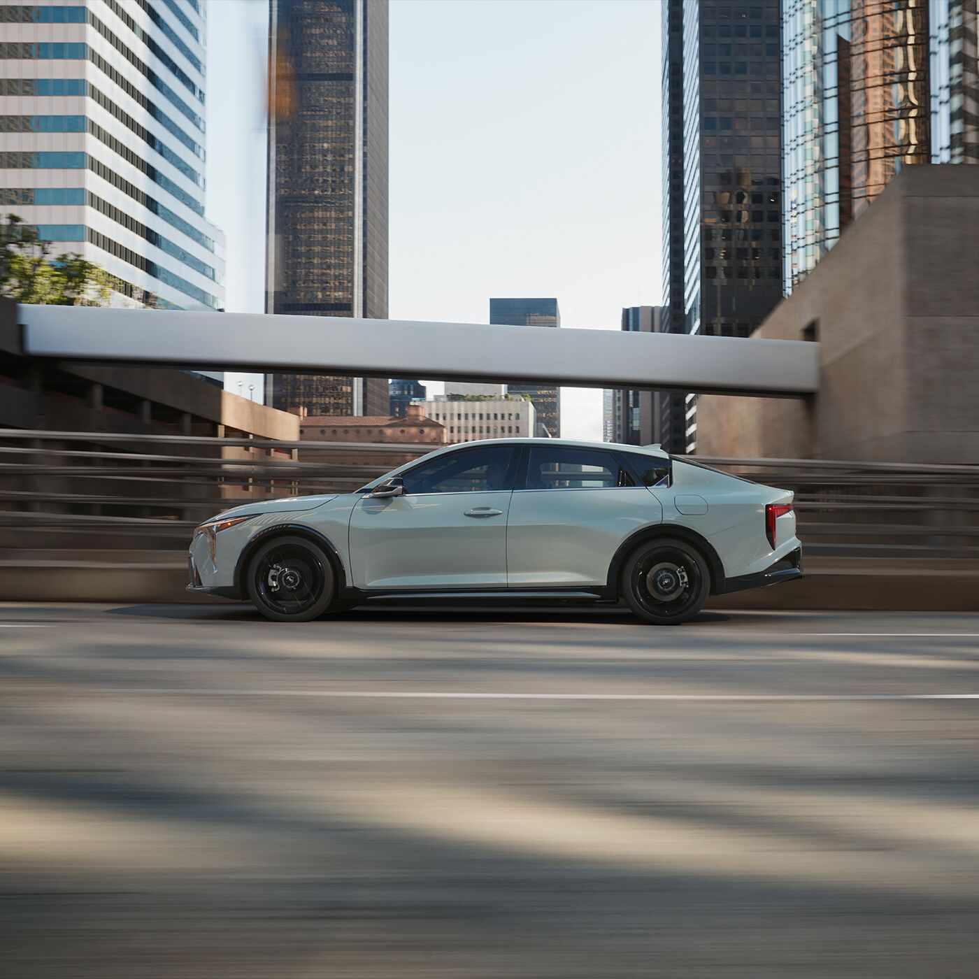 2025 Kia K4 driving down the road