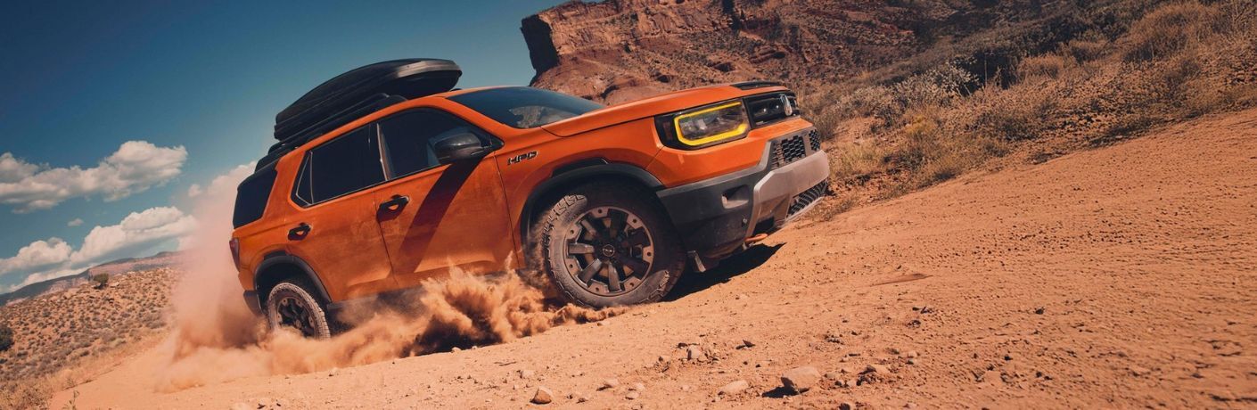 side view of the 2025 Honda Passport in the sand