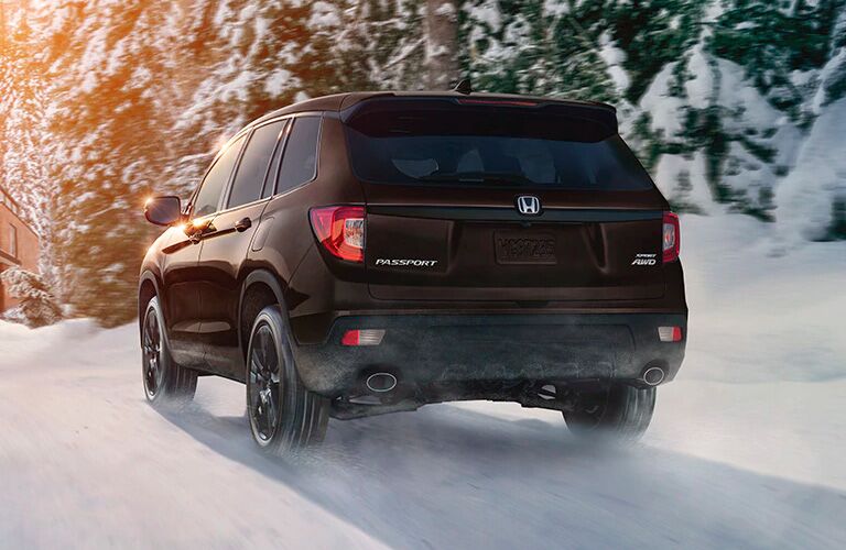 2021 Honda Passport driving down a snowy road 2021 Honda Passport driving down a snowy road