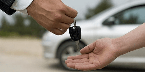 Man handing car keys to woman Man handing car keys to woman