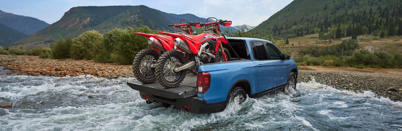 2025 Honda Ridgeline rear view crossing a stream