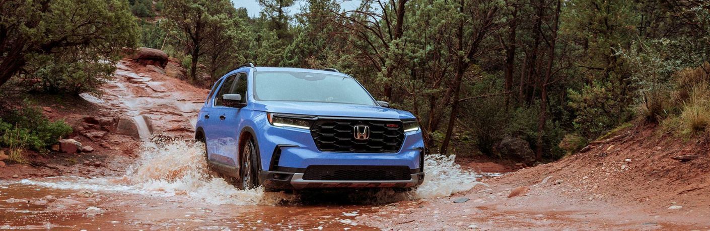 front quarter view of the 2025 Honda Pilot navigating a stream