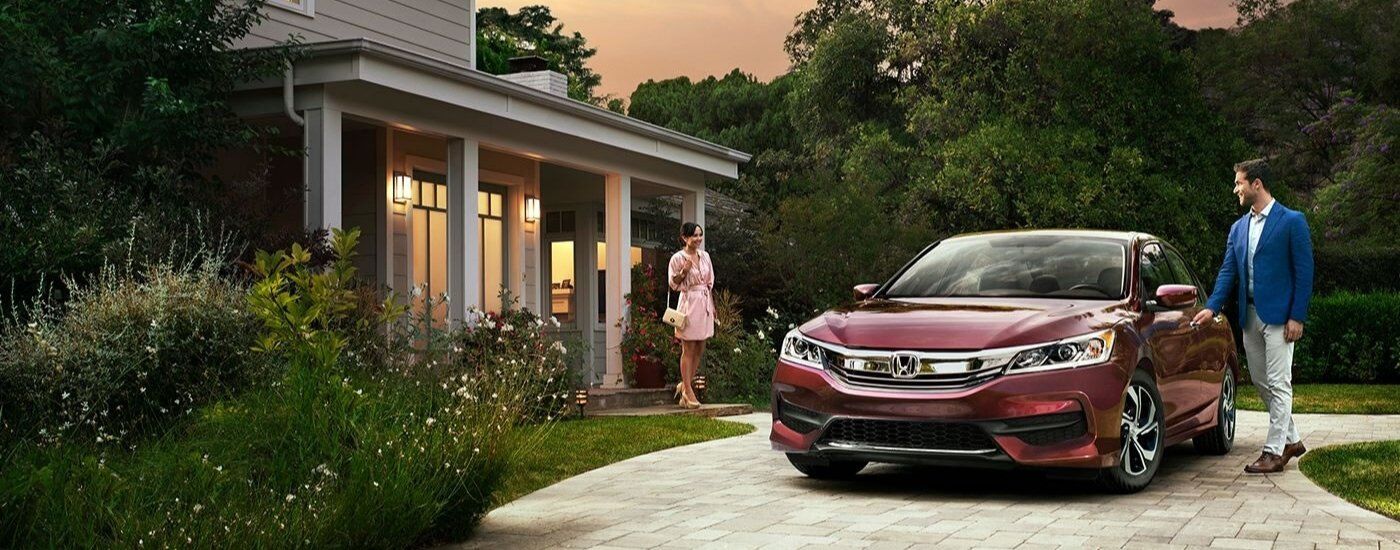 Red 2017 Honda Accord LX parked on a driveway near a building.