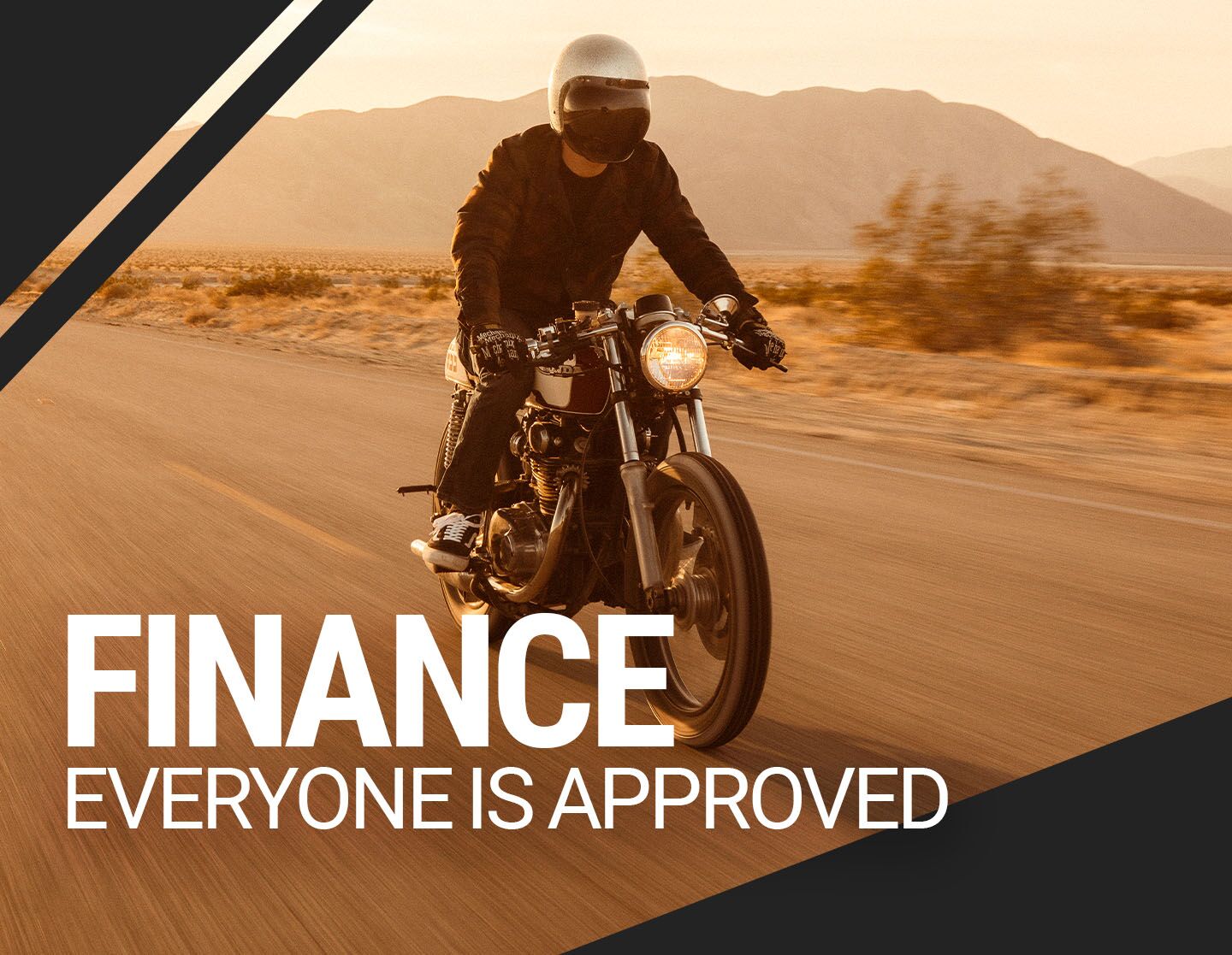 Man riding motorcycle on desert road