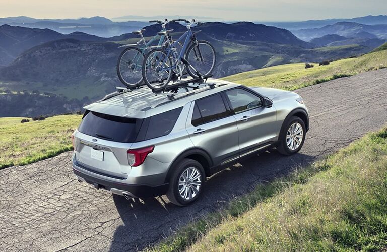 2021 Ford Explorer driving down a mountain road with bikes attached to the roof 2021 Ford Explorer driving down a mountain road with bikes attached to the roof