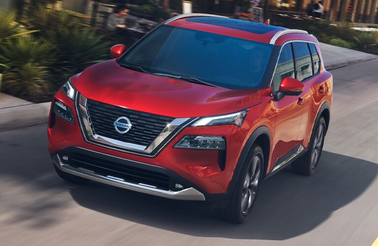 2021 Nissan Rogue driving down a city street 2021 Nissan Rogue driving down a city street