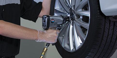 Tires professionally installed by VW Certified Technicians Volkswagen mechanic with air wrench working on tire