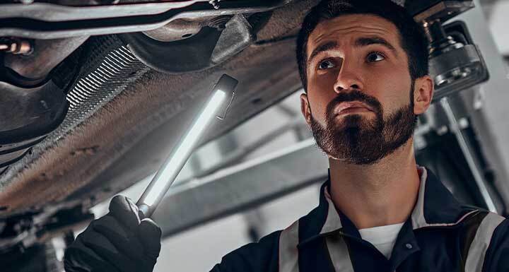 Special Service Discounts Volkswagen Mechanic looking under car