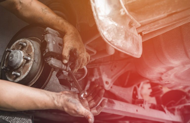 Technician fixing the brake pad in a car