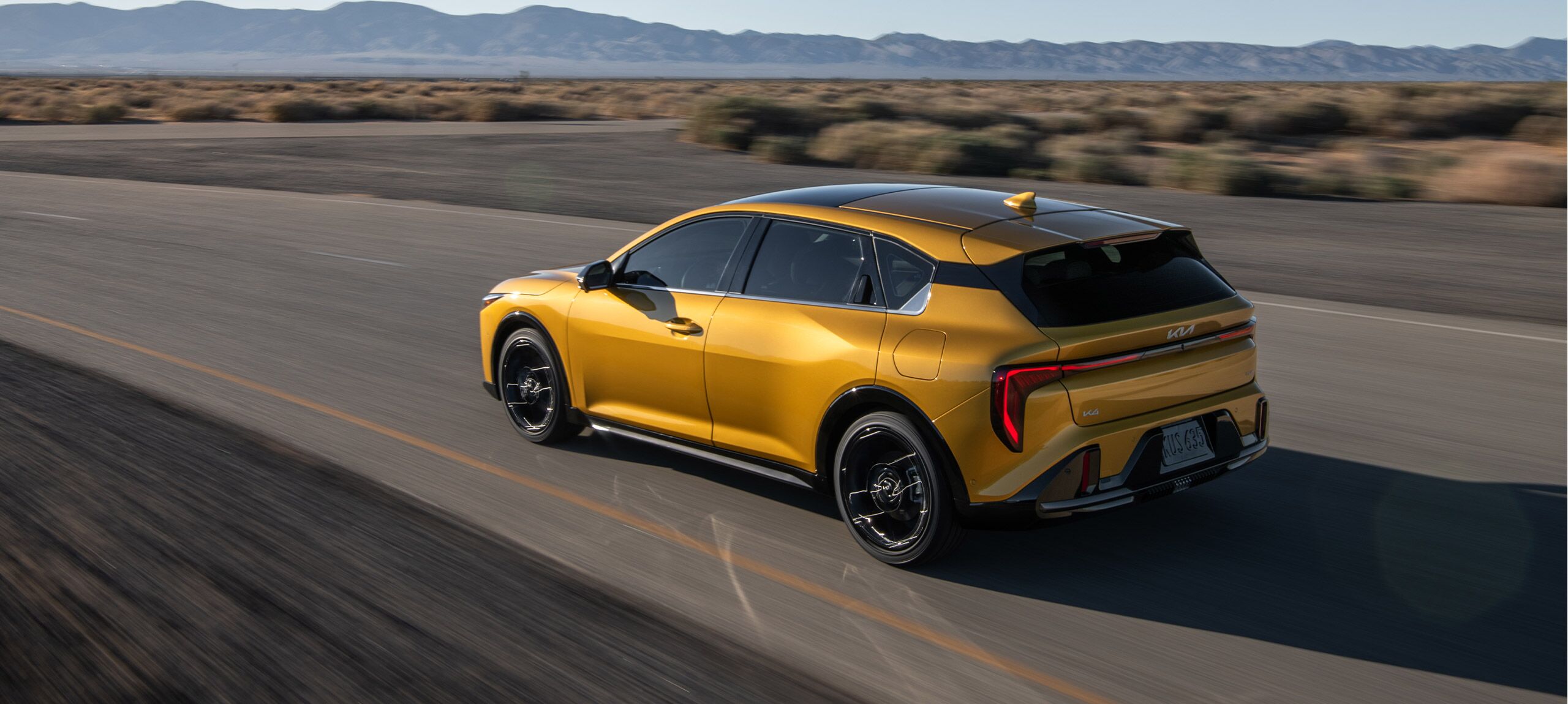 2026 Kia K4 Hatchback driving down the road