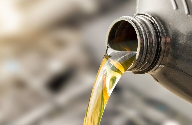 Oil being poured from a container Oil being poured from a container