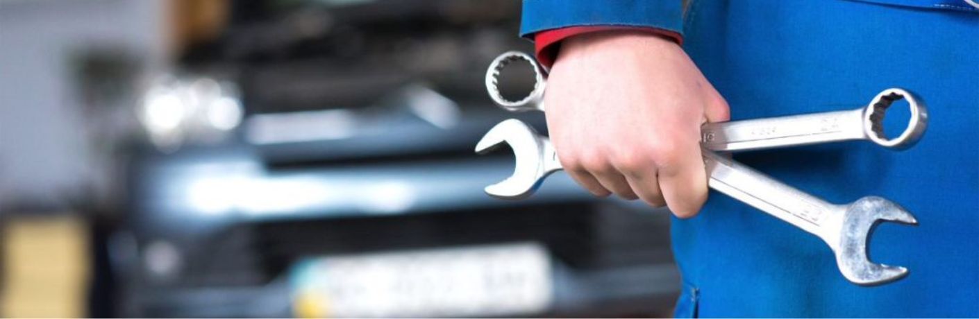 Car mechanic's hand with tools