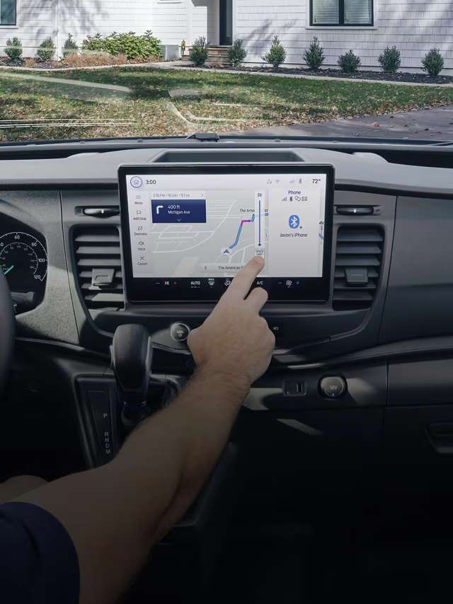 A side view of the 2024 Ford E-Transit cargo van on a city street. A side view of the 2024 Ford E-Transit cargo van on a city street.