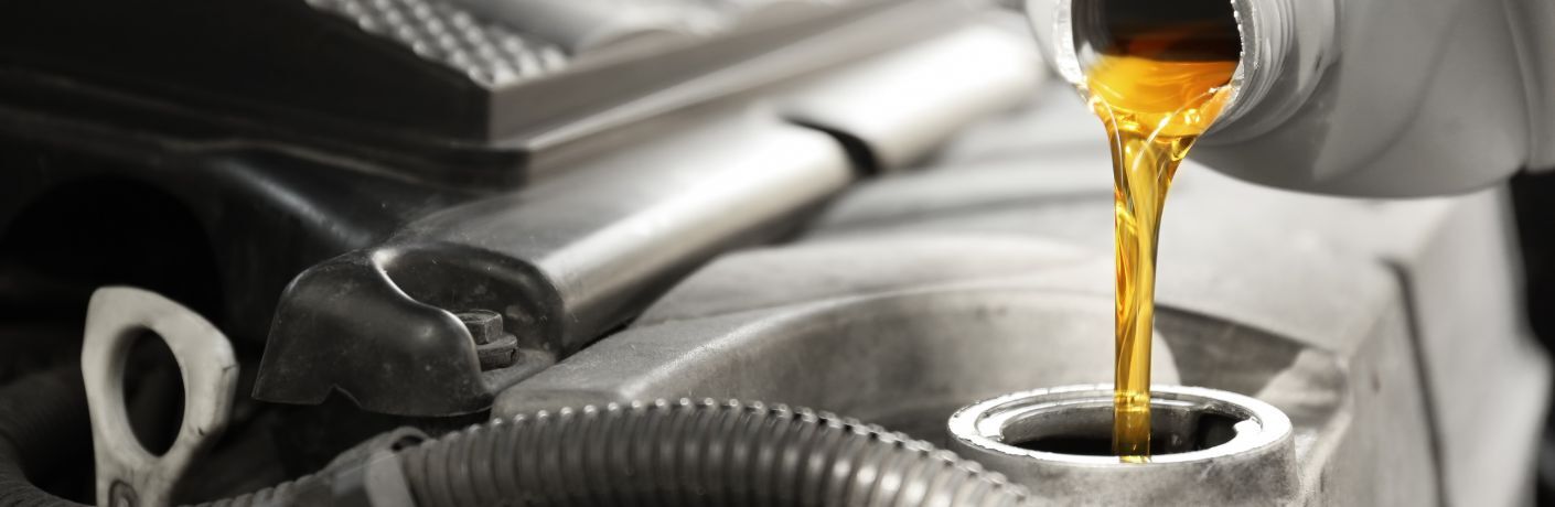 Oil being poured into the vehicle