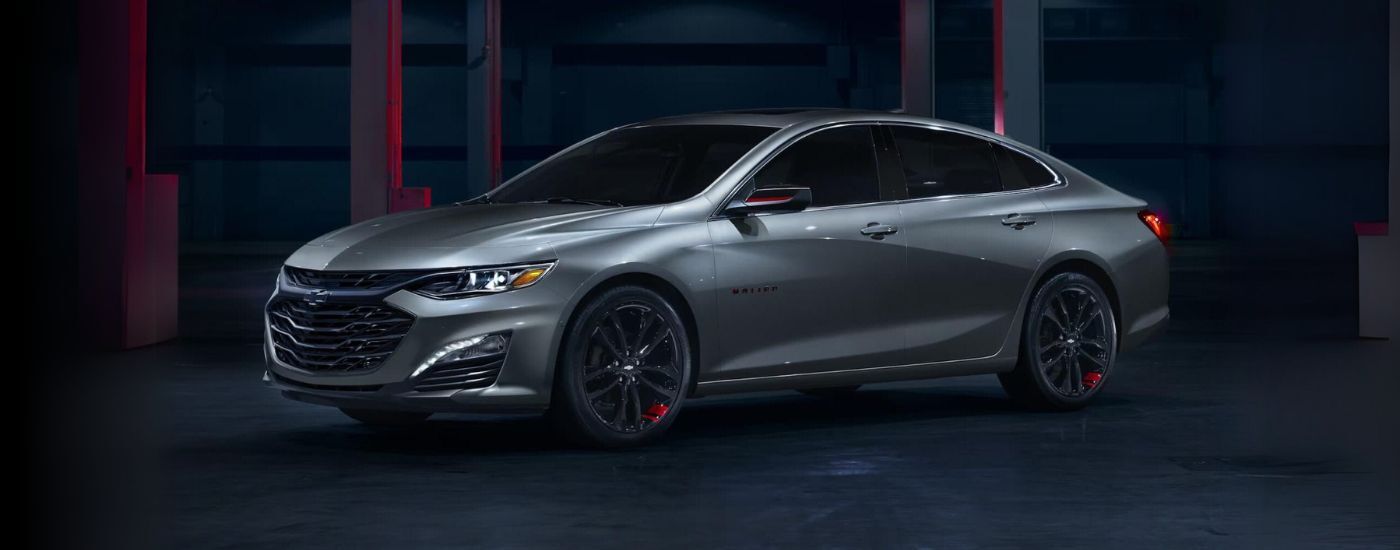A silver 2024 Chevy Malibu Redline parked in a warehouse