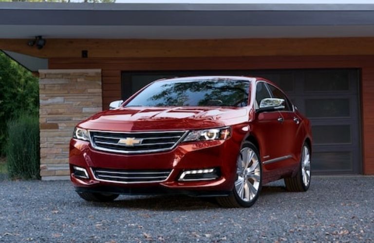 Chevrolet Impala in Red parked outside a house Chevrolet Impala in Red parked outside a house