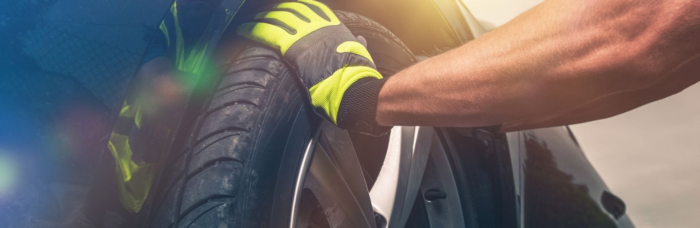 Technician adjusting a tire during a tire rotation service