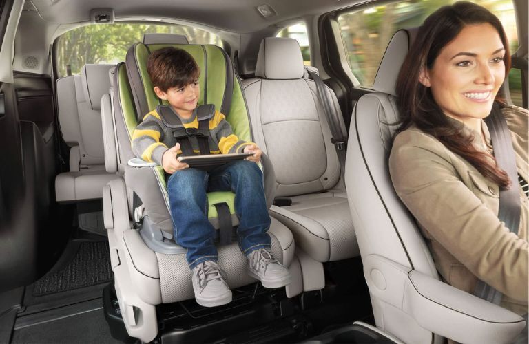 Kid sitting in the child seat in the back as his mother drives the 2024 Honda Odyssey
