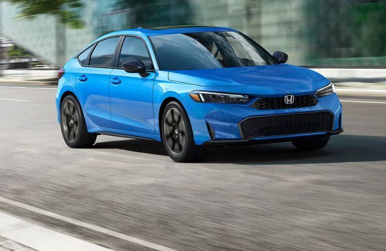 2026 Honda Civic Hatchback Hybrid Blue on the road