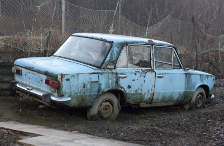 representative image of a rusty and old car