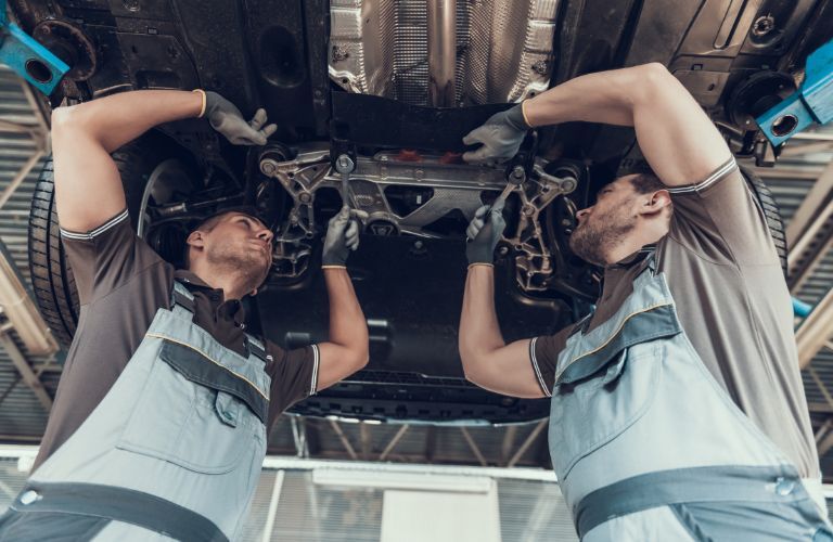 Technician checking the underside of the vehicle