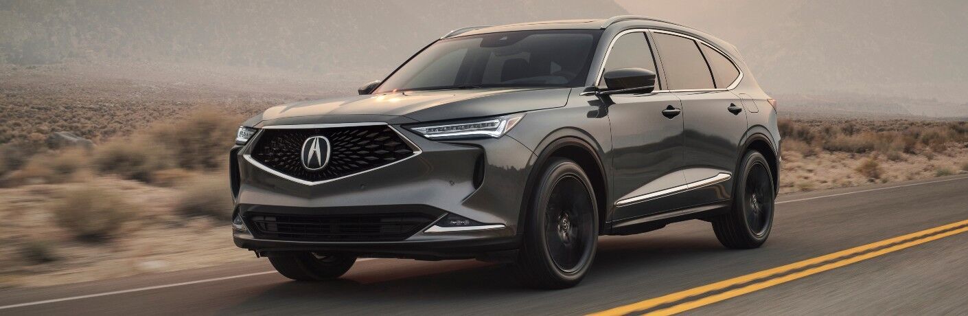 Used Acura MDX Gray driving on the road Used Acura MDX Gray driving on the road