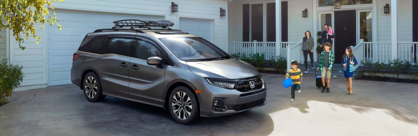 a family walking towards the 2026 Honda Odyssey
